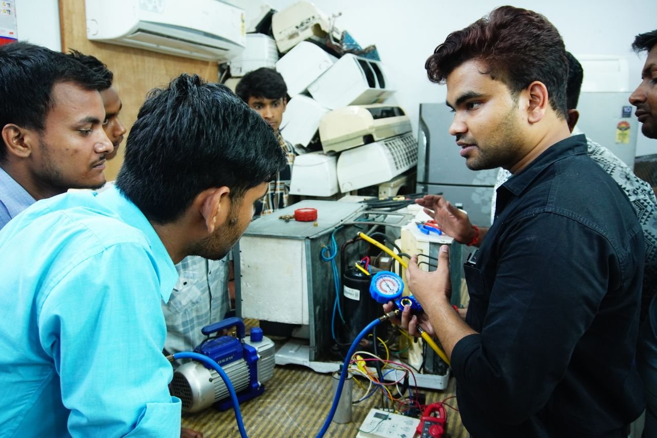 gallery-6 Participants learn AC repair during a hands-on session in Delhi, India.